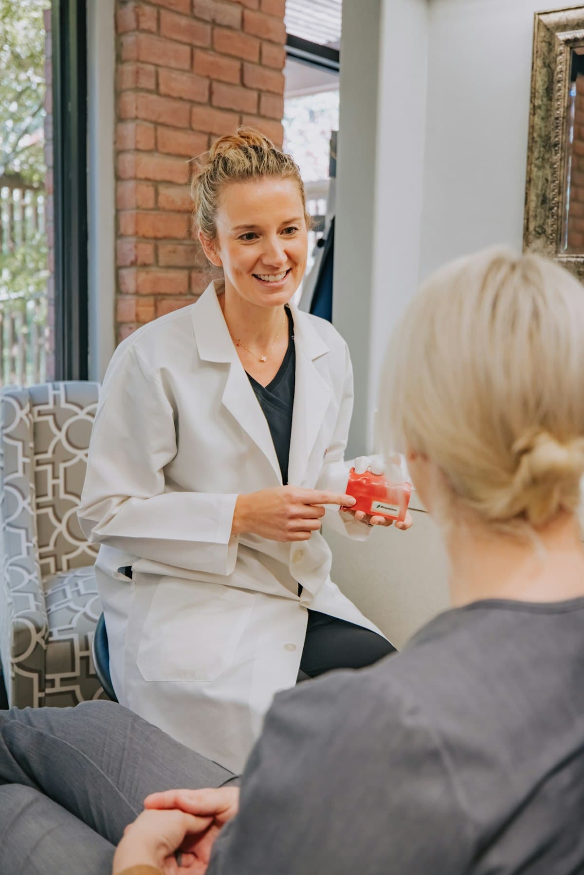 Dentist reassuring a patient during a friendly consultation